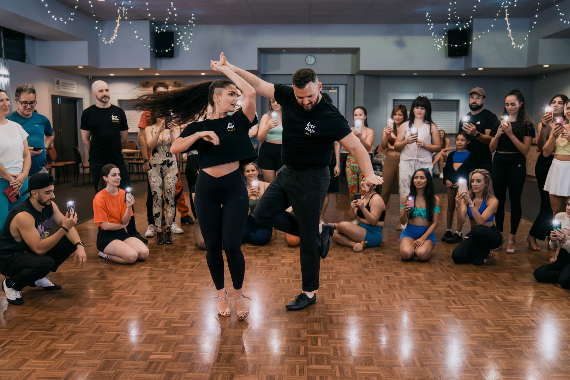 Alex and Madalyn doing a turn, dancing in front of the class