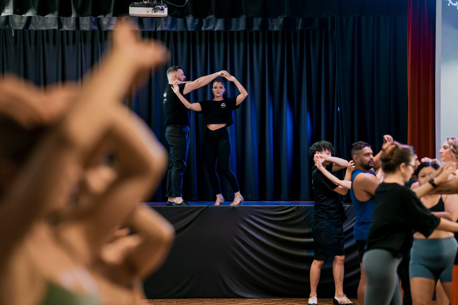 Alex and Madalyn on stage in front of a class